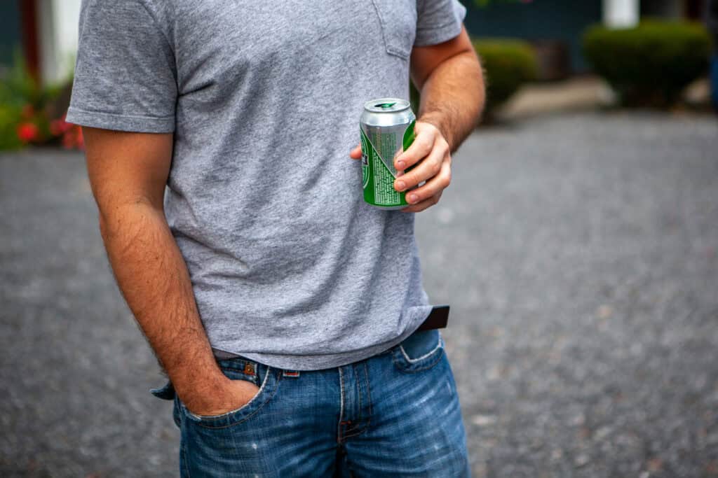 man holding can of beer