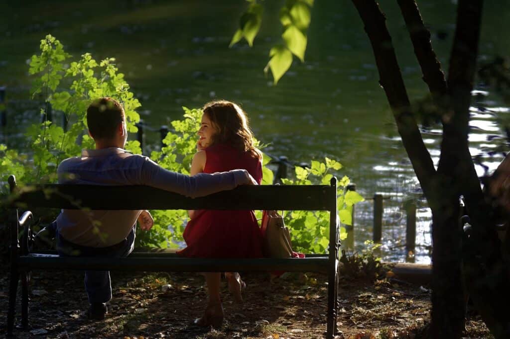 guy and girl talking on bench