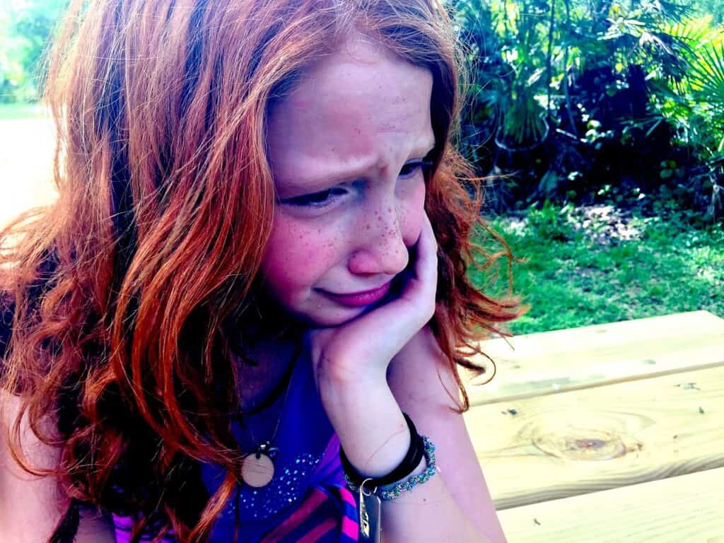 girl crying head in hand