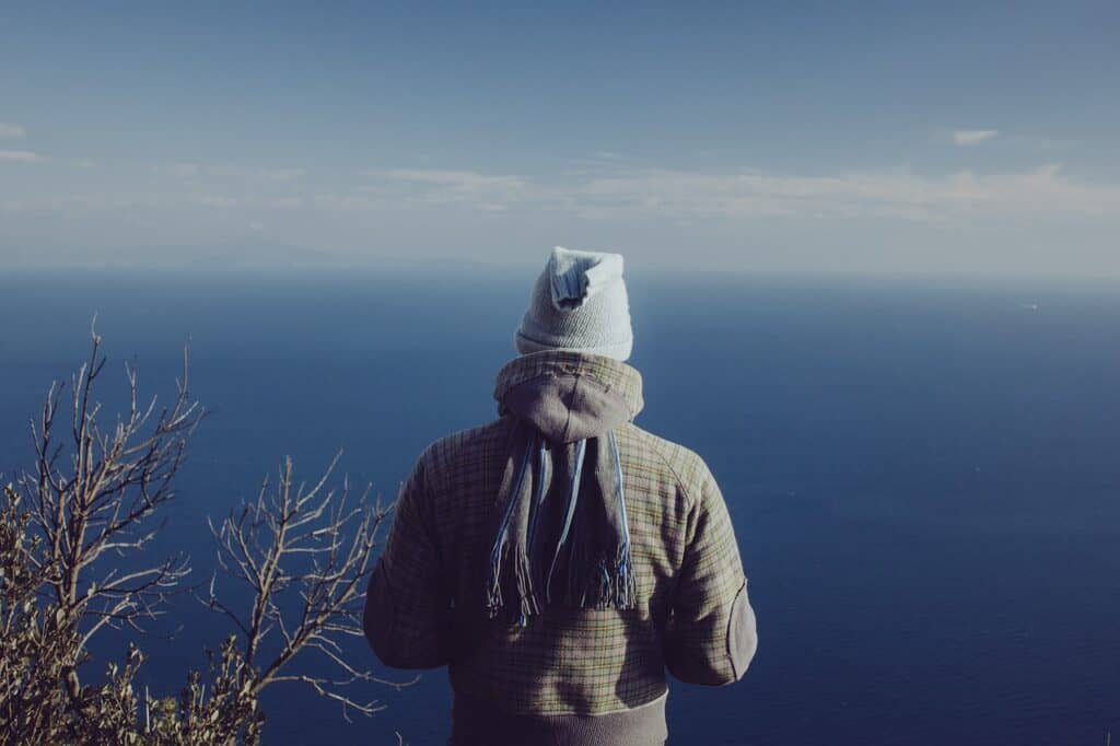 man looking out over ocean back of head