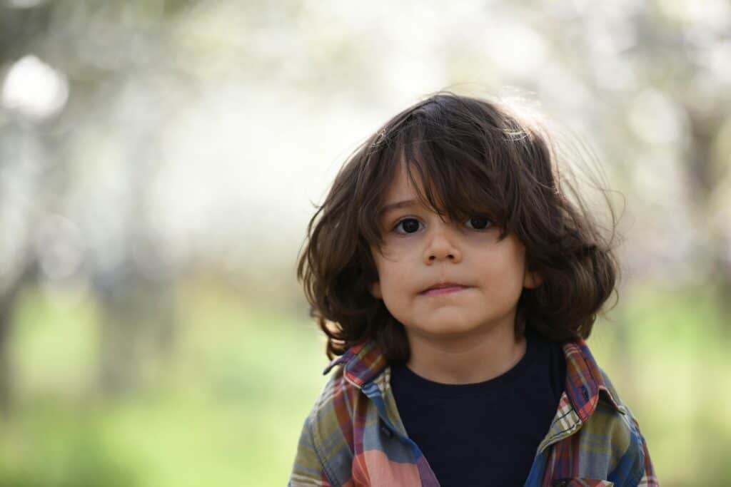 boy with long hair looking straight ahead