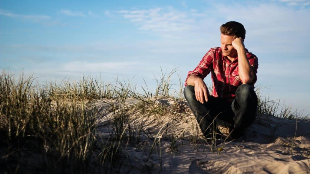 man on beach sad