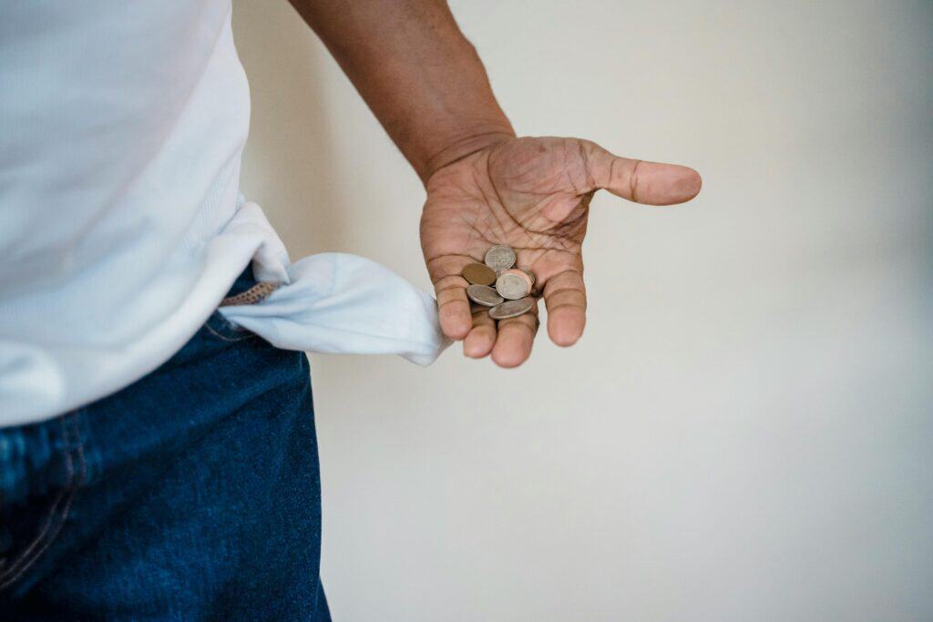 Man puling out pocket holding change