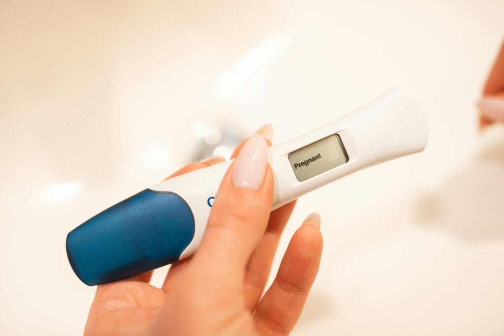 pregnancy test positive woman hand holding test