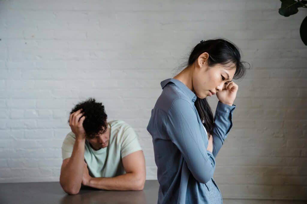 man at table woman standing upset