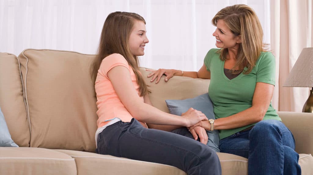 Mother have a happy engagement on sofa