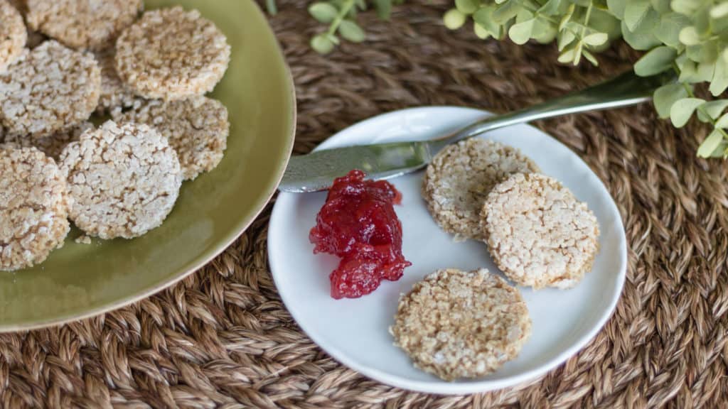 A serving of Irish Oatcakes on a plate, with a larger plate of cakes next to it